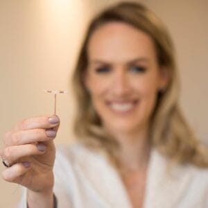 Imagem da Dra. Sibele Klitzke segurando o diu de longa duração, muito utilizado como método contraceptivo